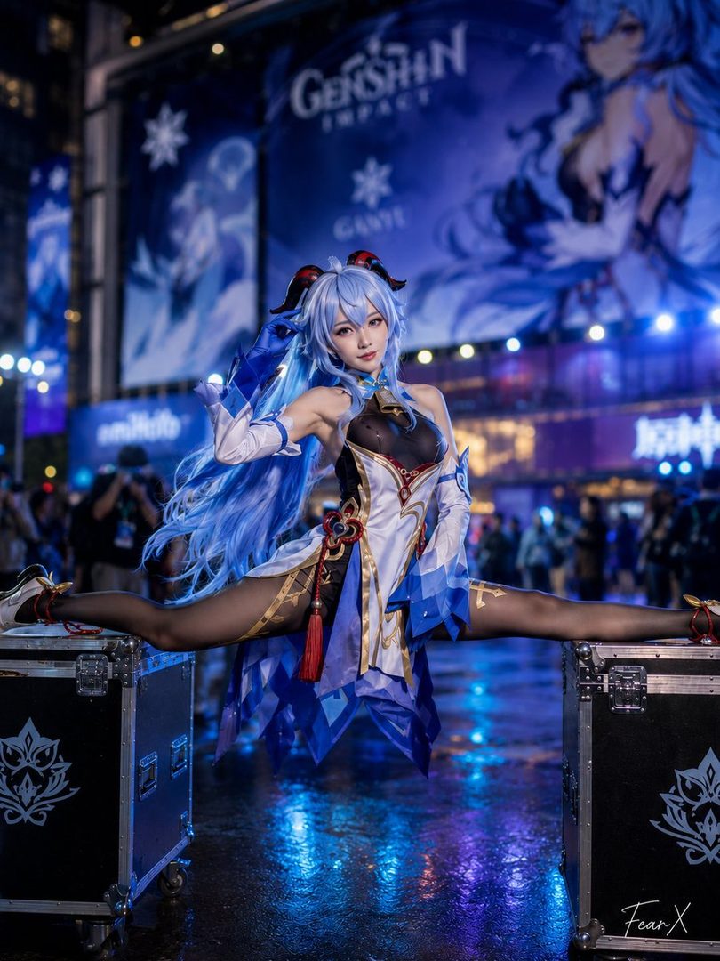 A cosplayer dressed as Ganyu from Genshin Impact performs a split on stage at night.