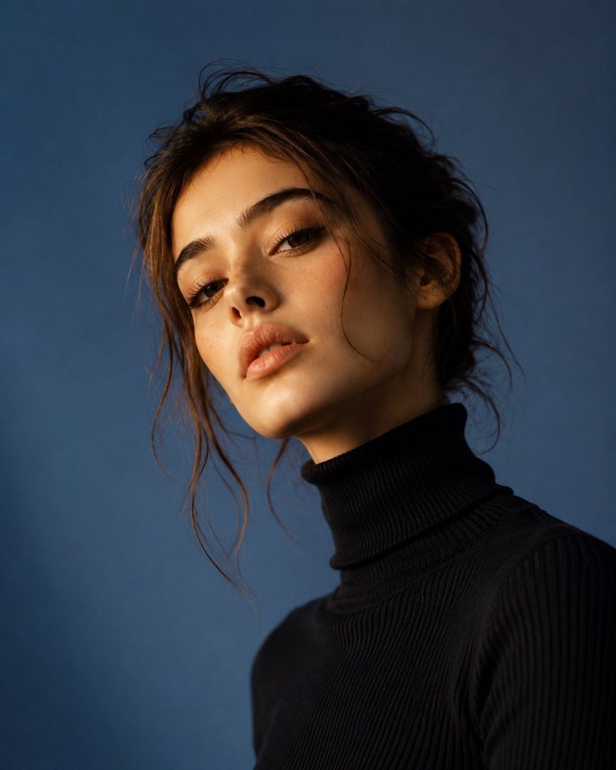 A photorealistic portrait of a young woman with dark hair pulled back, wearing a black turtleneck sweater, against a blue background.