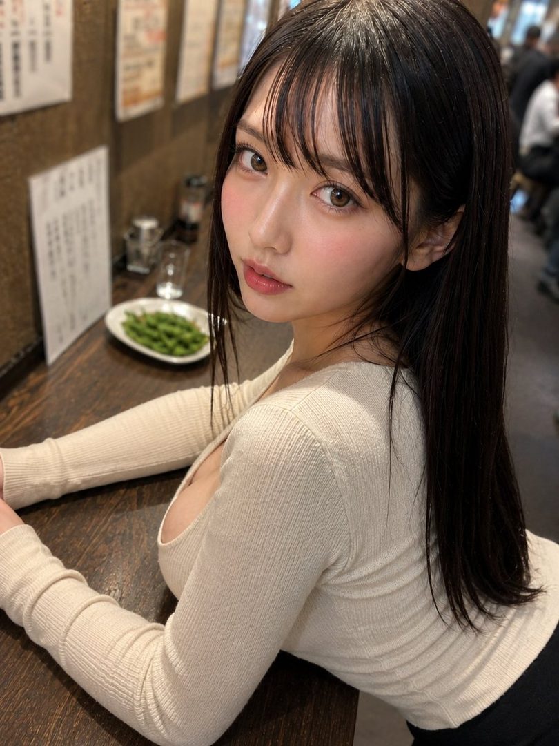 A young East Asian woman with long black hair and bangs, wearing a cream-colored long-sleeved top, poses for a portrait in an indoor setting.