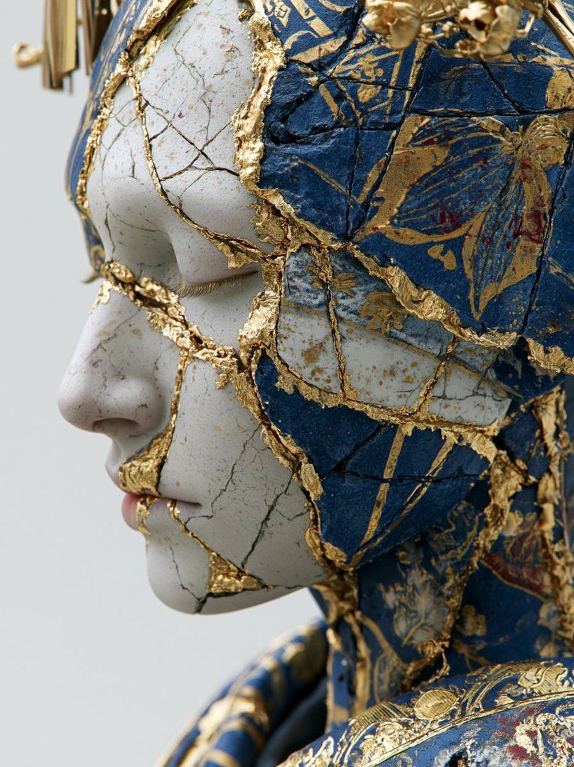 A profile portrait of an AI-generated woman with a cracked porcelain-like face adorned with blue and gold patterns, in the style of Kintsugi.