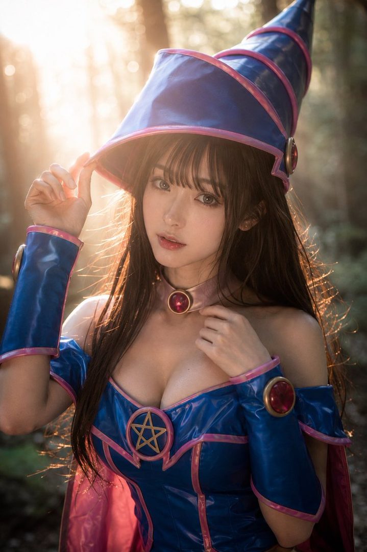 A woman cosplaying as Dark Magician Girl from Yu-Gi-Oh! in a forest, wearing a blue and pink costume and wizard hat, with sunlight filtering through the trees.