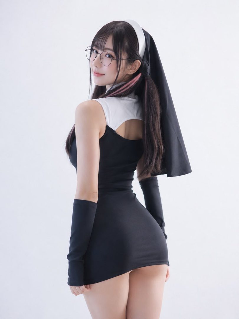 A woman in a black and white nun-like mini dress with glasses and pigtails looks over her shoulder in a studio setting.