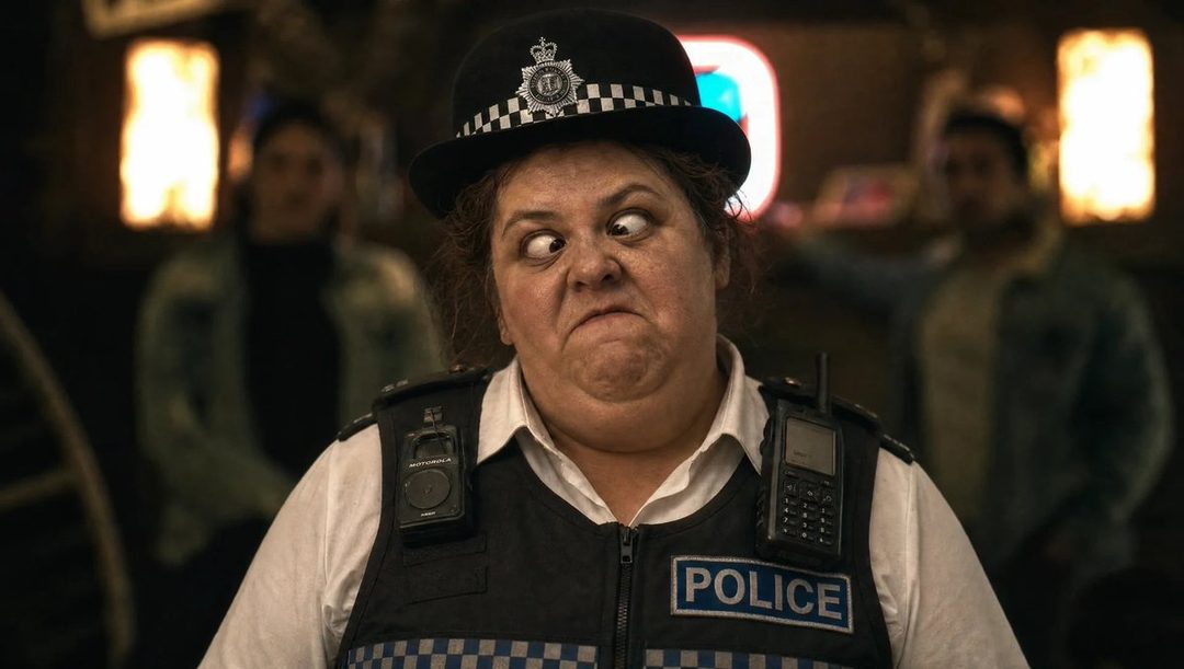 A woman in a police uniform makes a funny face with crossed eyes.