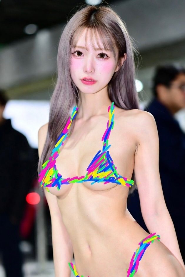 A young woman with long silver hair in a minimal bikini covered by colorful scribbles, posing indoors.