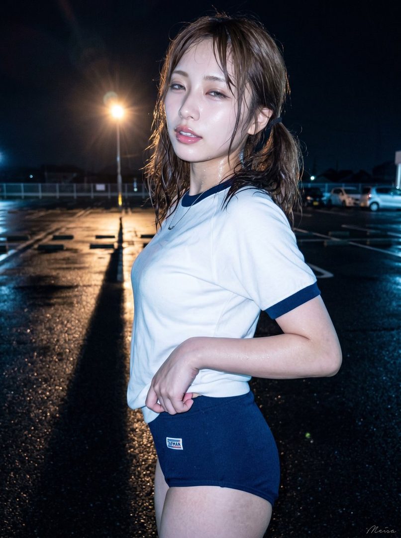 Young woman in a wet gym uniform posing at night in a rainy parking lot under streetlights.