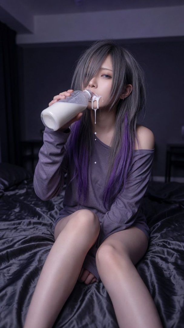 A person with silver and purple hair drinks milk from a bottle, with milk dripping down their chin, while sitting on a bed.