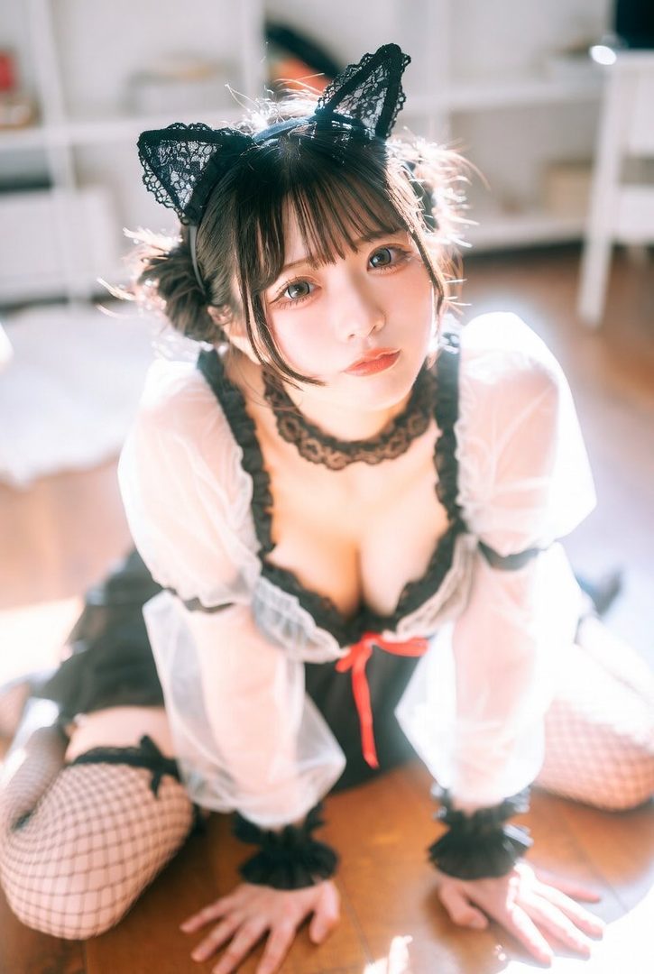 A cute East Asian woman in a black and white maid-like dress with cat ears and fishnet stockings kneels on a wooden floor, looking up at the camera.