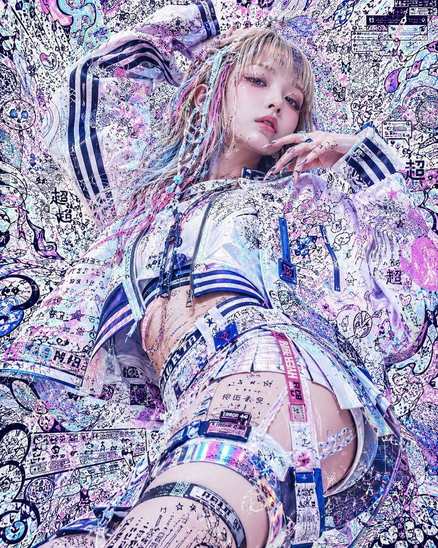 A futuristic-looking woman with blonde and colorful braided hair, wearing a cropped jacket and mini skirt with garters, against a vibrant, abstract background.