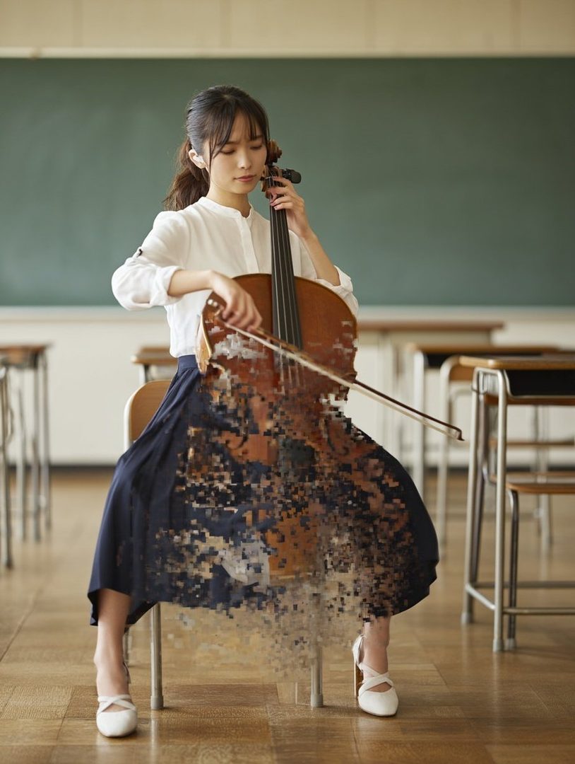 A young woman with a ponytail plays a cello that is pixelating into dust in a classroom.