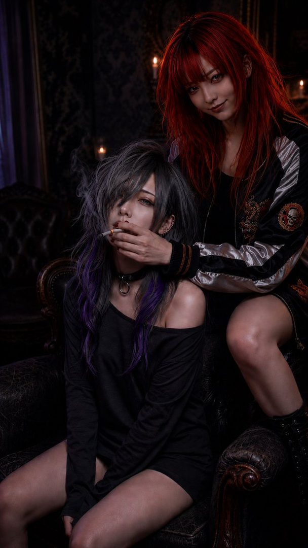 Two women in a dark, gothic setting, one with red hair in a bomber jacket and the other with black and purple hair in an off-shoulder top, holding a cigarette.