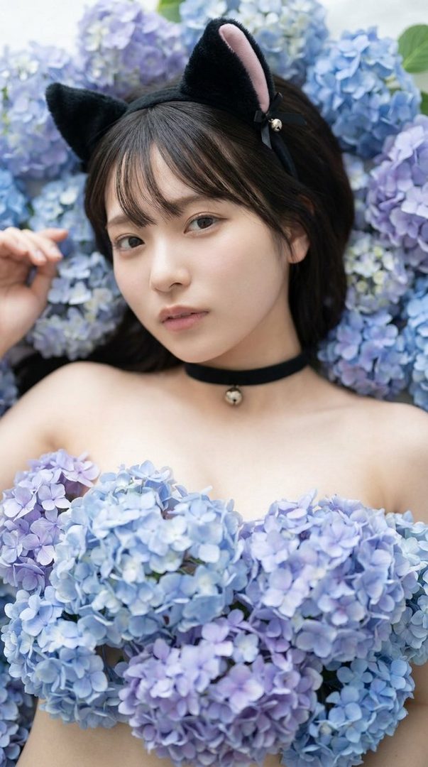 A young woman with black hair and cat ears lies among blue and purple hydrangeas, wearing a choker with a bell.