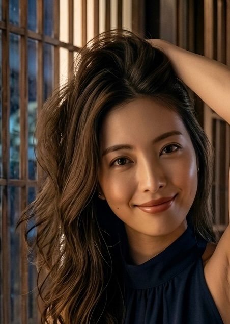 A photorealistic portrait of a smiling woman with long brown curly hair, wearing a dark blue top, posing indoors.