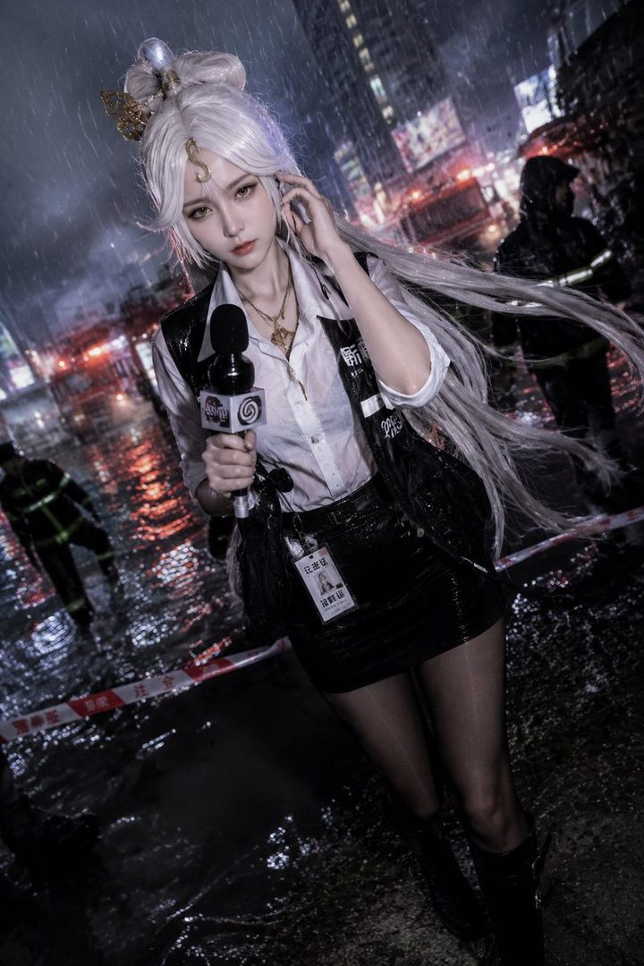 A woman with long white hair, dressed as a reporter, stands in the rain at night holding a microphone.