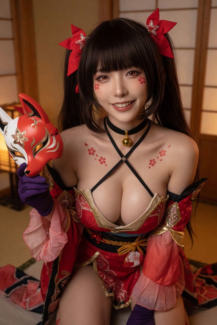 A smiling woman in a red kimono-style outfit with twintails and bangs, holding a fox mask, with cherry blossom patterns on her cheeks and chest.