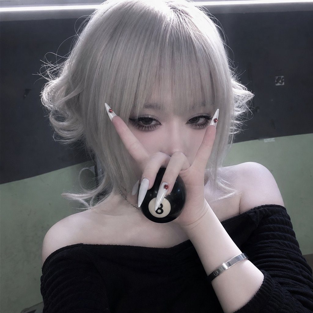 A person with silver hair and an off-the-shoulder black top holds an 8-ball and makes a rock-and-roll hand gesture.