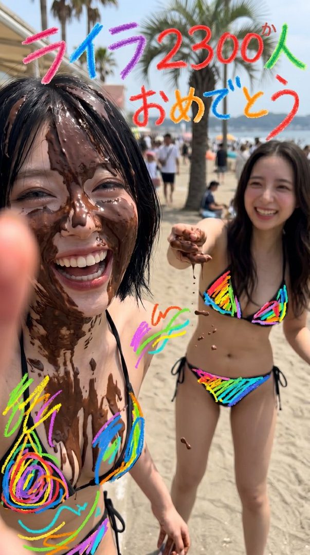 Two young women in rainbow bikinis are playing with chocolate on a sunny beach, with one covered in chocolate and laughing, and the other holding chocolate.