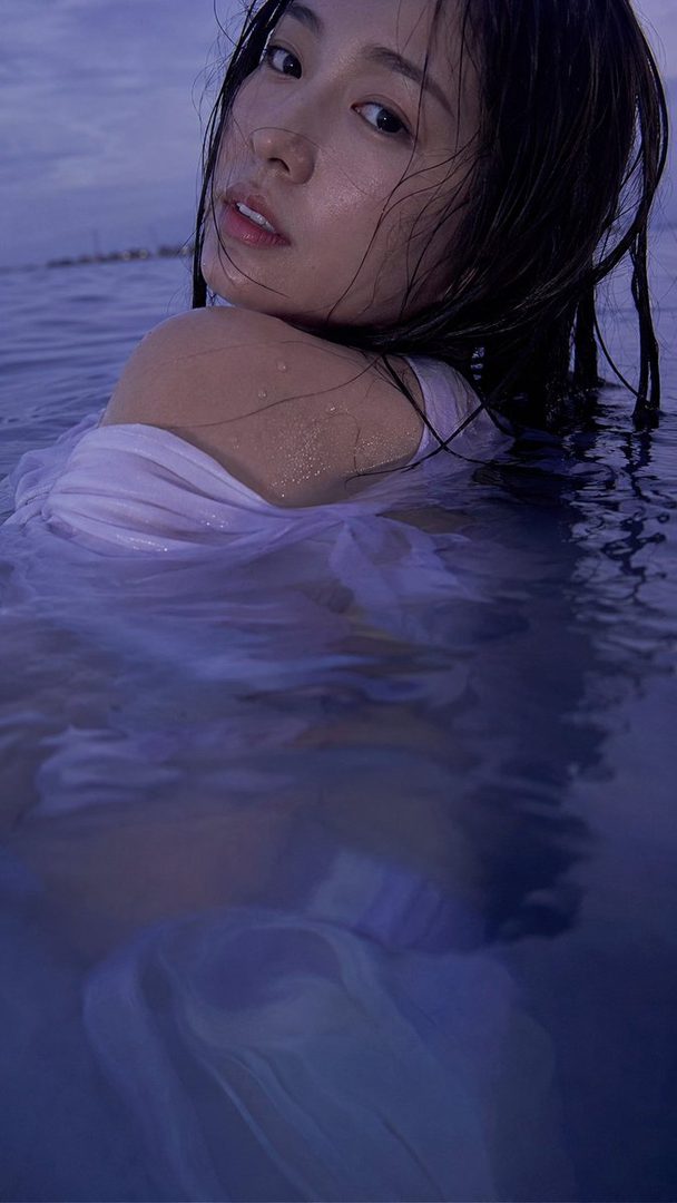 A photorealistic portrait of a Japanese woman with wet black hair, partially submerged in dark blue water, looking back at the camera.