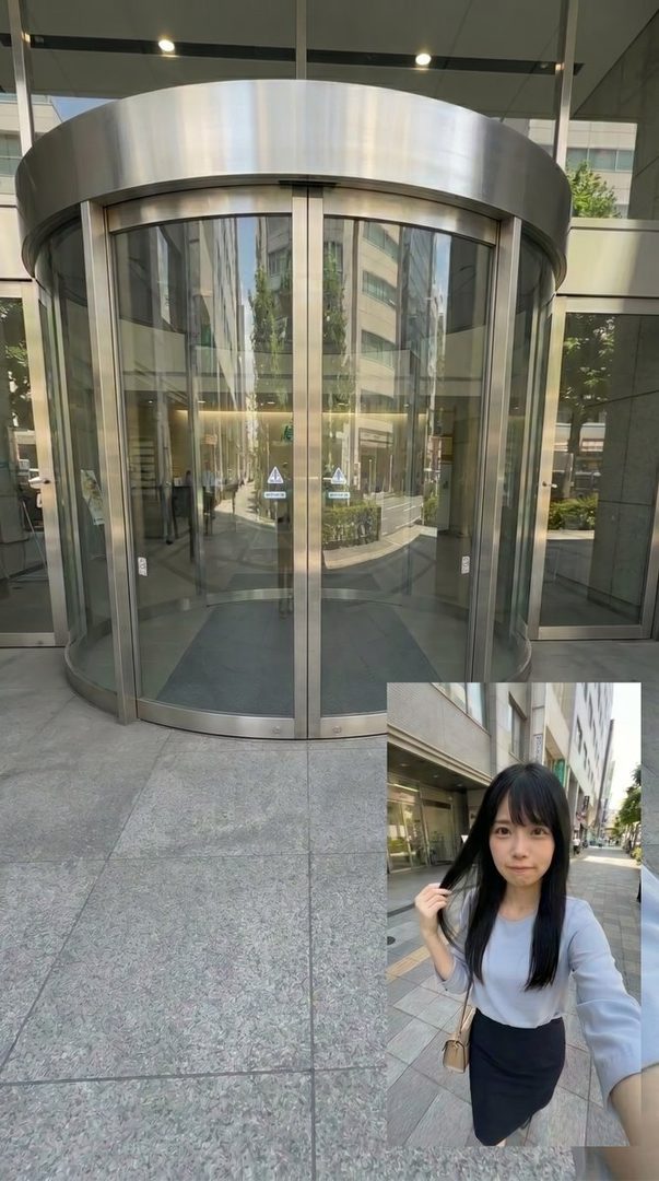 A young woman with long black hair and bangs takes a selfie on a city street, wearing a light blue blouse and a black skirt.