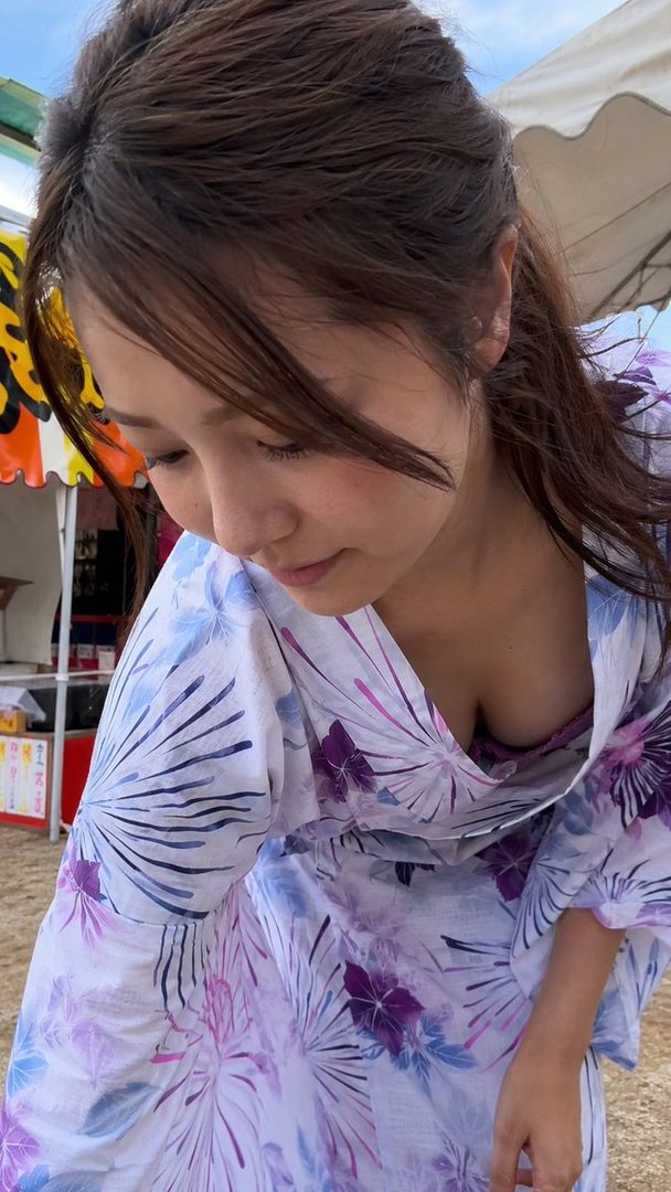 A photorealistic image of a Japanese woman in a yukata, bending forward, showing cleavage, at a summer festival.