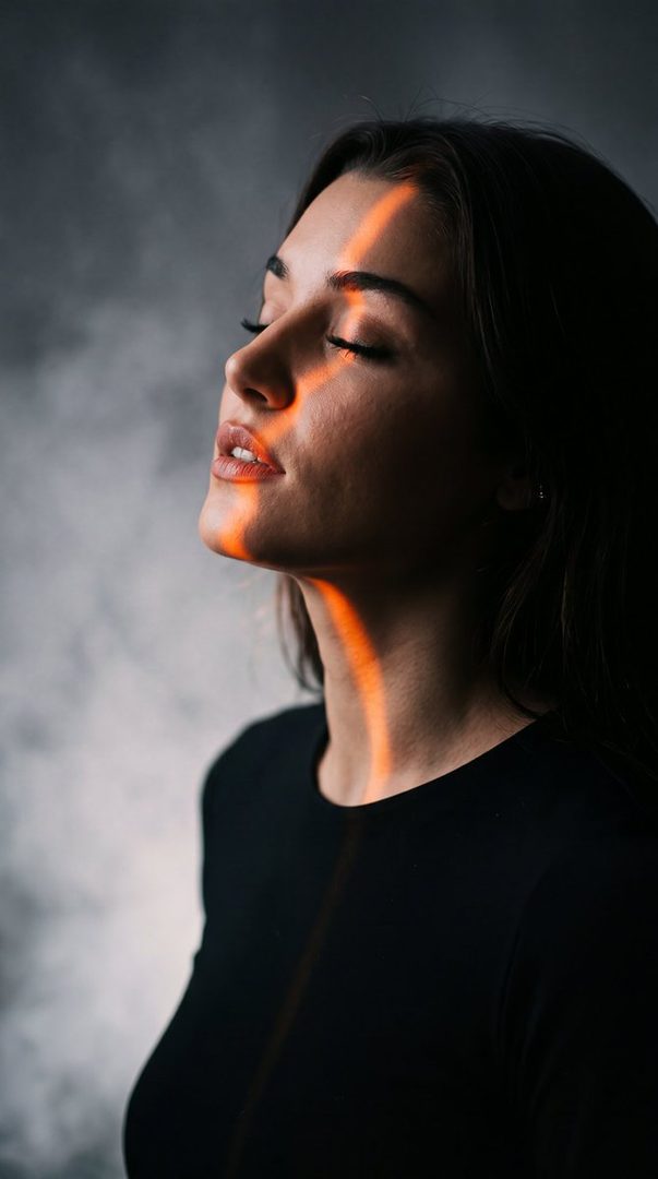 A photorealistic portrait of a woman with closed eyes and parted lips, illuminated by an orange light streak across her face and neck, against a smoky grey background.