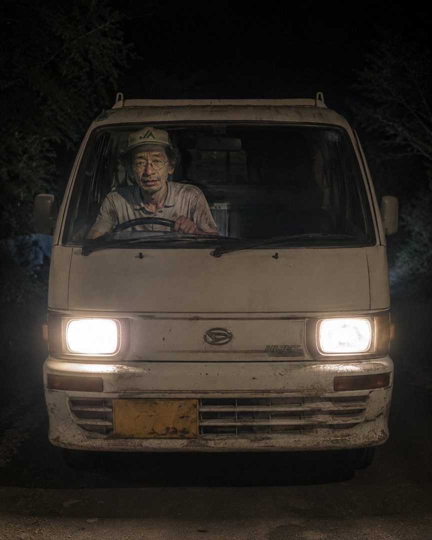 A photorealistic image of an older man with glasses and a cap driving a white van at night, illuminated by the headlights.