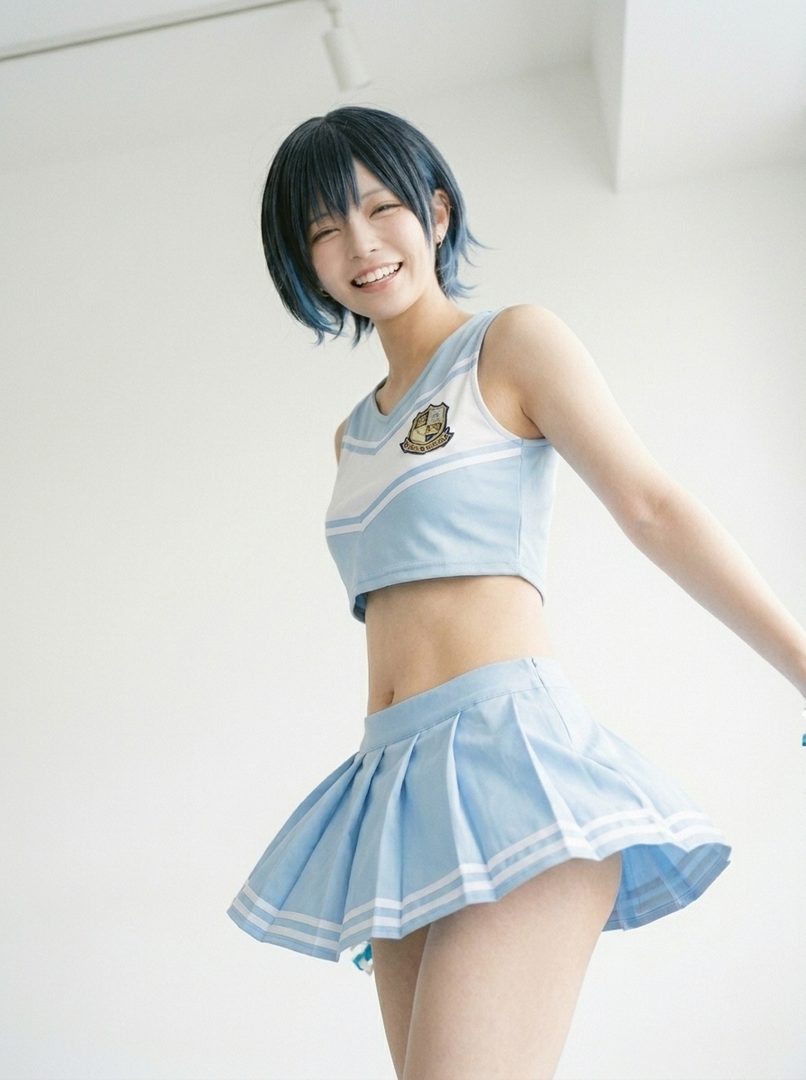 A young woman with short blue-black hair smiles brightly, wearing a light blue and white cheerleader-style crop top and a matching pleated skirt.