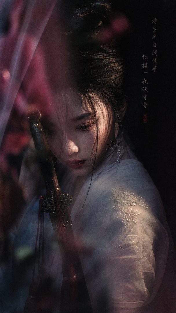 A beautiful East Asian woman with long black hair, dressed in traditional attire, holding a sword, with a dreamy and cinematic mood.