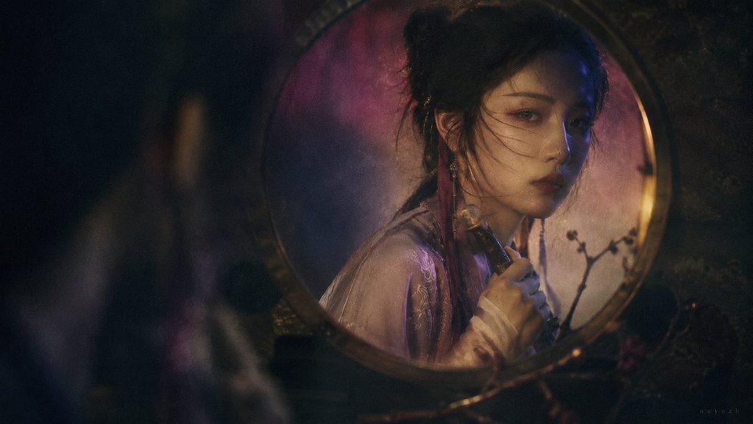 A young East Asian woman with dark hair styled in a bun, wearing traditional Chinese clothing, looks into a decorative mirror with a thoughtful expression.